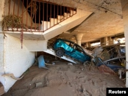 A view shows a damaged car, following a powerful storm and heavy rainfall hitting the country, in Derna